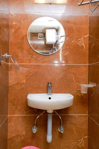a bathroom with a sink and a mirror on the wall at Bhavan Resorts in Yercaud
