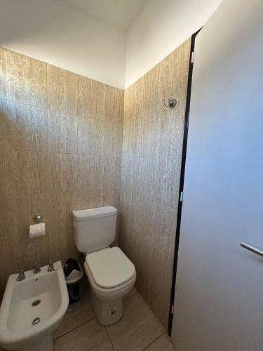 a bathroom with a toilet and a sink at Las Artes Lodge in Mina Clavero