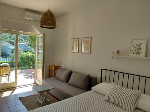 a living room with a bed and a couch at Apartmani Tia in Neum