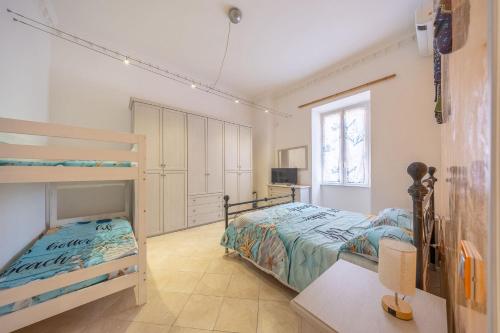 a bedroom with two bunk beds and a window at Piazza Pia Suites in Anzio