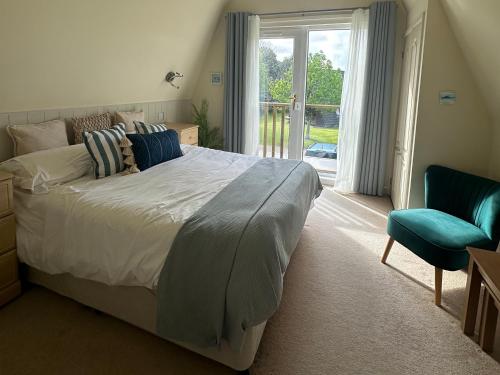 a bedroom with a large bed and a window at Lodge 22, Bodmin Holiday Park, Cornwall in Lanivet