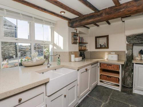 a kitchen with a sink and a window at High Ickenthwaite Farmhouse in Ulverston