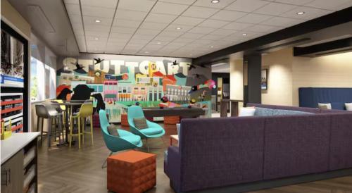 a living room with a couch and a table and chairs at Tru By Hilton Ciudad Valles in Ciudad Valles