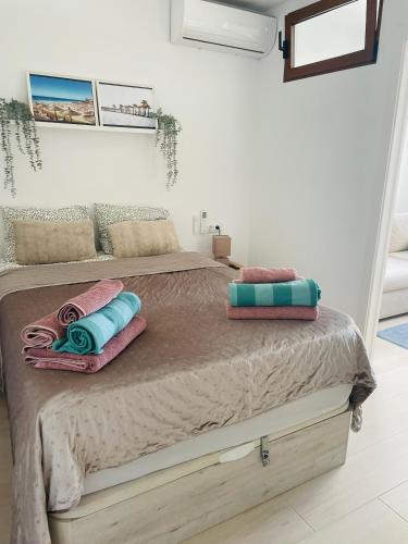 a bed with two pillows on it in a room at Hidden Gem Playa Flamenca Apartment with Pool View - Oleza Garden in Playa Flamenca