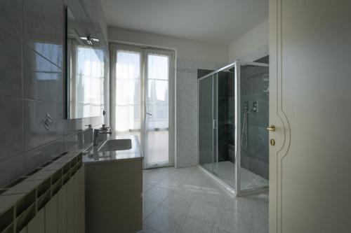 a bathroom with a glass shower and a sink at Villa La Corte in Cesa