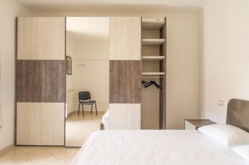 a bedroom with a sliding door leading into a room at Villa La Corte in Cesa