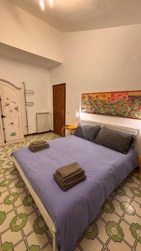 a bedroom with a large bed with two towels on it at A casa nostra in Formello