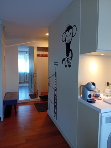 a kitchen with a monkey sticker on the wall at Grīvas apartamenti in Ogre