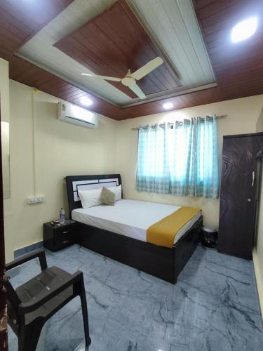 a bedroom with a bed and a ceiling fan at Ambient Homestay NESTEASY in Nashik