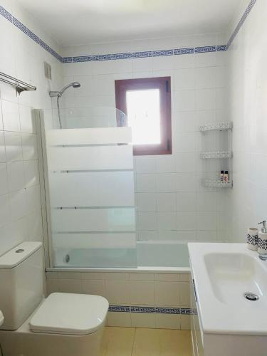 a bathroom with a toilet and a shower and a sink at Hidden Gem Playa Flamenca Apartment with Pool View - Oleza Garden in Playa Flamenca