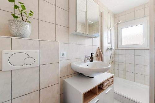 a white bathroom with a sink and a mirror at Four Seasons in Krautheim