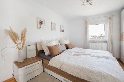 a bedroom with a bed and a window at Four Seasons in Krautheim