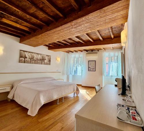 a bedroom with a bed and a desk in it at La Dolce Vita in Riomaggiore