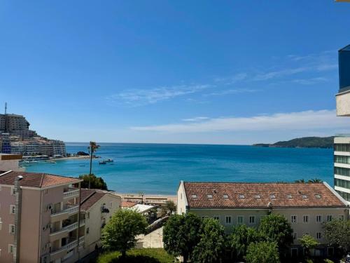 a view of the ocean from a city at Beachfront Rafailovici - Budva in Rafailovici