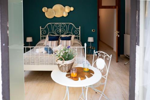 a bedroom with a bed with a table and chairs at B&B ELEGANT LENA in Salerno