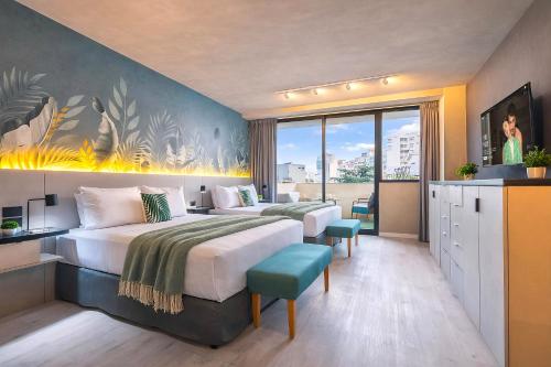 a hotel room with two beds and a balcony at Deluxe Apartments in Palermo - by BueRentals in Buenos Aires
