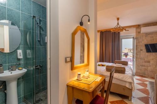 a bathroom with a bed and a shower and a sink at Wiena Apartments in Ulcinj