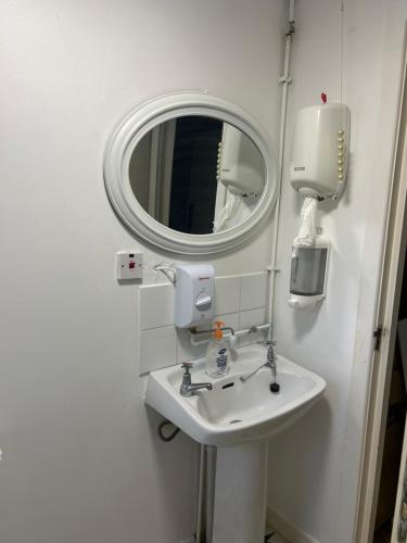 a bathroom with a sink and a mirror at 7 The Diamond in Ballycastle