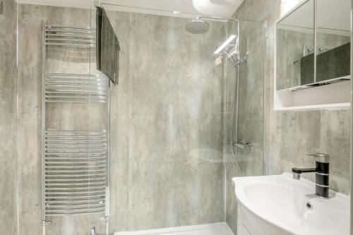 a bathroom with a shower and a sink and a mirror at 1 Bed in Beccles oc-65080 in Beccles