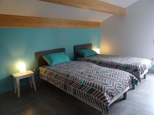 a bedroom with a bed and a side table at Airellier du Pilat in Marlhes