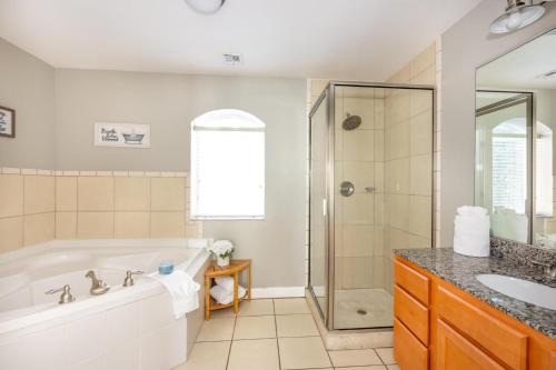 a bathroom with a tub and a shower at Mountain View Condo 1306 in Pigeon Forge