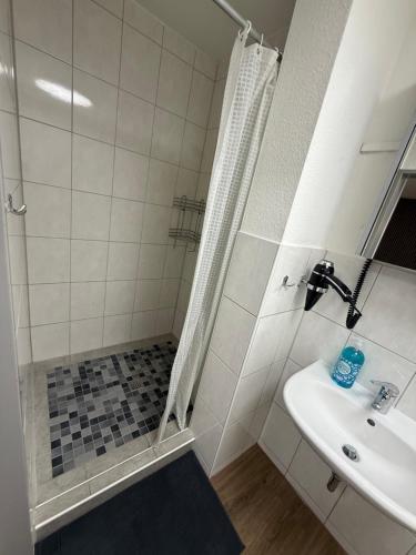 a bathroom with a shower and a sink at Garland-Rooms in Bremen