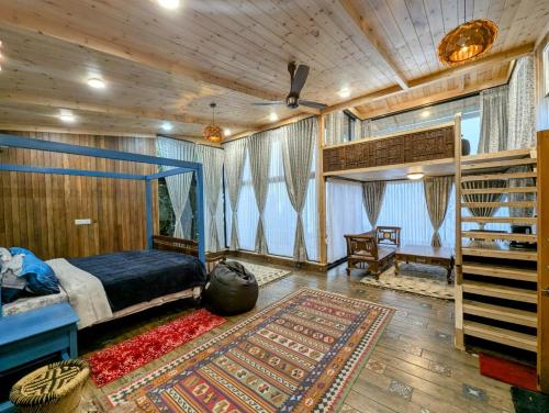 a bedroom with a bed and a staircase in a room at Cloudwalks Homestay in Kodaikānāl
