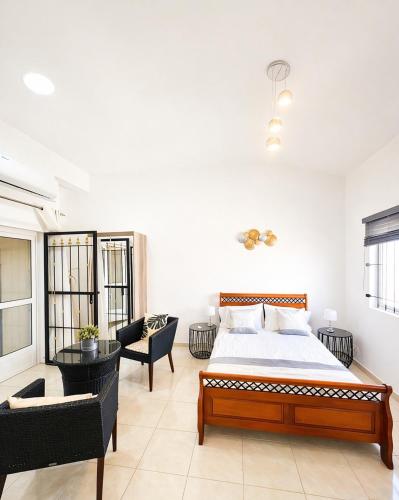 a bedroom with a bed and a living room at Sea La Vie Villa in Grande Gaube