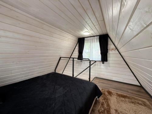 a room with a bed in a small room at A-frame У Евелінки in Vorokhta
