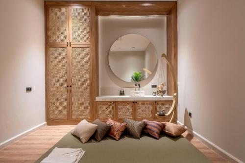 a living room with a couch in front of a mirror at The Marni Hotel & Spa - Adults Only 12 Plus in Antalya