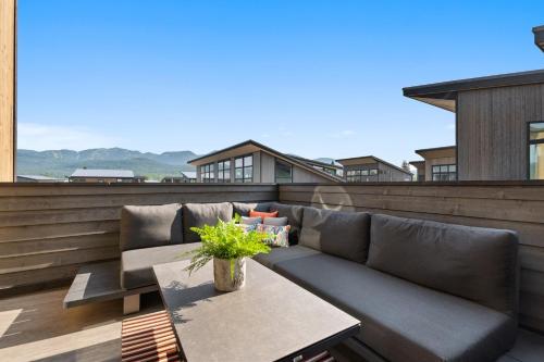 a patio with a couch and a table on a balcony at Quarry B10 in Whitefish