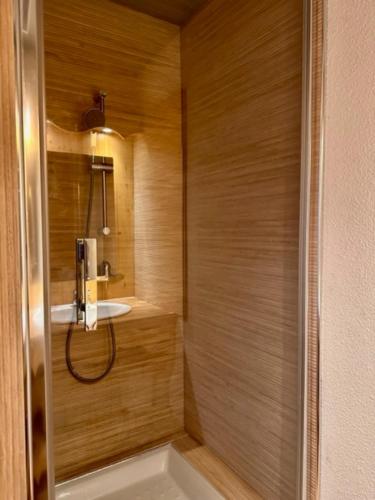 a bathroom with a shower with a sink at Duplex « les 7 Marmottes », 306 in Chamrousse