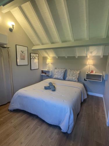 a bedroom with a large white bed in a room at Le Clos d Emilie in Saint-Marcel