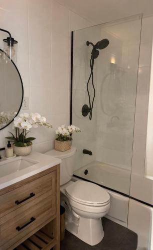 a bathroom with a toilet and a sink and a shower at Azur East, Southampton in Southampton