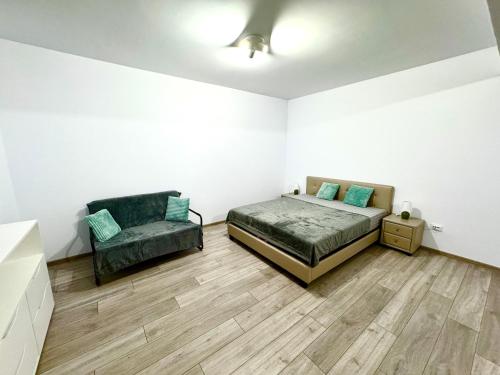 a bedroom with a bed and a chair in it at David Apart in Otopeni