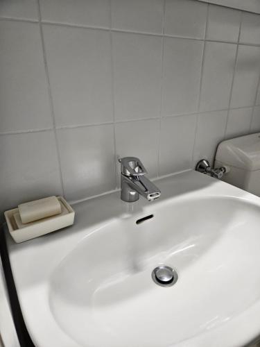 a white bathroom sink with a faucet on it at Ferienwohnung Daliah in Wangels