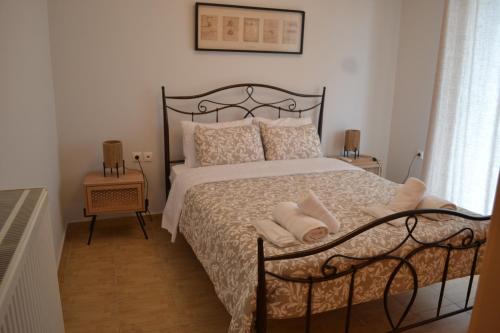 a bedroom with a black bed with pillows on it at Skala Central Comfort Apartment in Skála