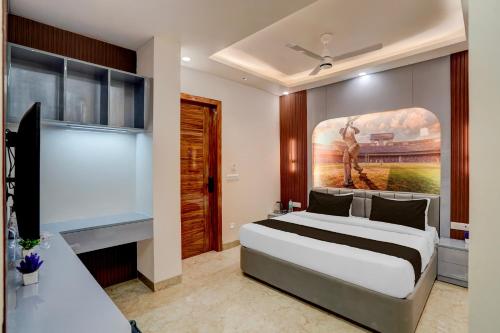 a bedroom with a bed and a painting on the wall at Hotel O Maruti Hotel in Indirapuram