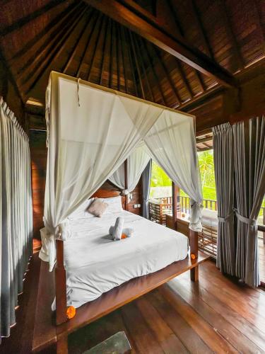 a bed with a canopy in a room at Escape To Paradise With Private Pool in Silebeng