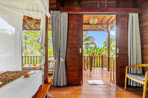 a bedroom with a bed and a balcony at Escape To Paradise With Private Pool in Silebeng