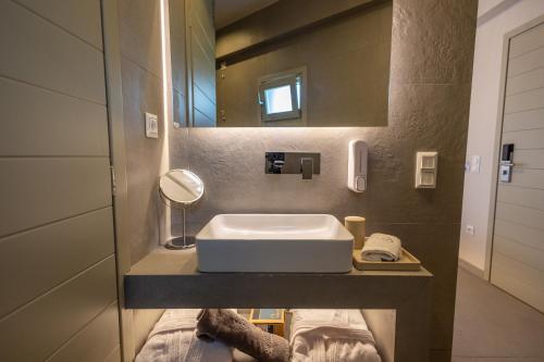 a bathroom with a sink and a mirror at Onar Hotel Kimolos in Kimolos