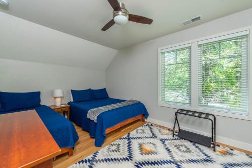 a bedroom with two beds and a ceiling fan at Lake Walk Cottage in Black Mountain