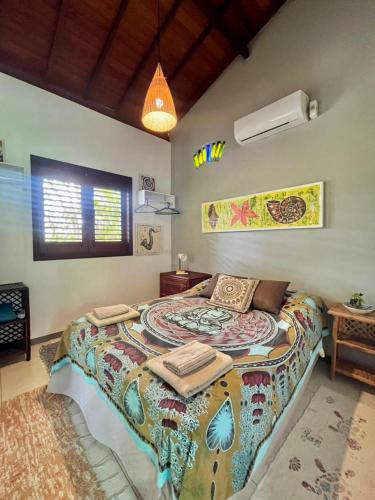 a bedroom with a large bed in a room at Chalé "Oasis" in Praia do Forte