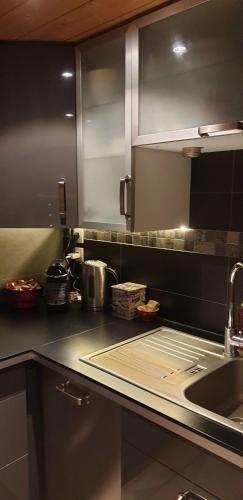 a kitchen with a sink and a counter top at « Le doux Chalet » Roche Béranger in Chamrousse