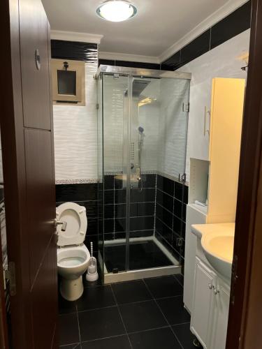 a bathroom with a shower and a toilet and a sink at Apartment sunah in Nador