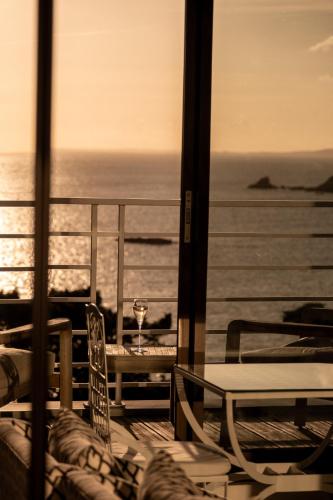 a view of the ocean from a balcony with a wine glass at Manoir de Lan Kerellec - Relais & Châteaux - Etoilé Michelin in Trébeurden