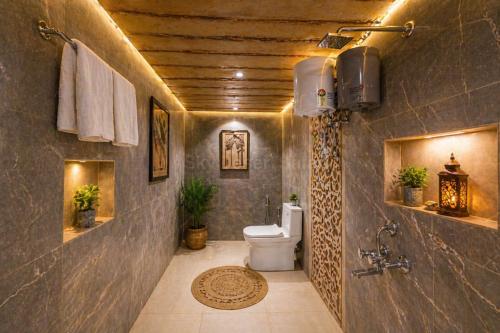 a bathroom with a toilet in a room with a ceiling at Sky Desert Safari Jaisalmer & Spa in Jaisalmer