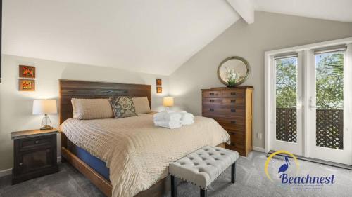a bedroom with a bed and a dresser and window at Casa Rio Del Mar in Aptos