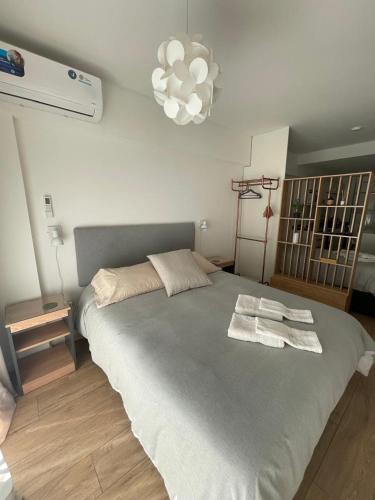 a bedroom with a large bed with towels on it at Depto Monroe 2 in Buenos Aires