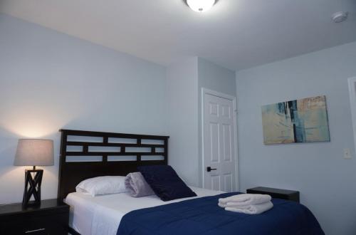 a bedroom with a large bed with a blue blanket at West New York room 14 in West New York